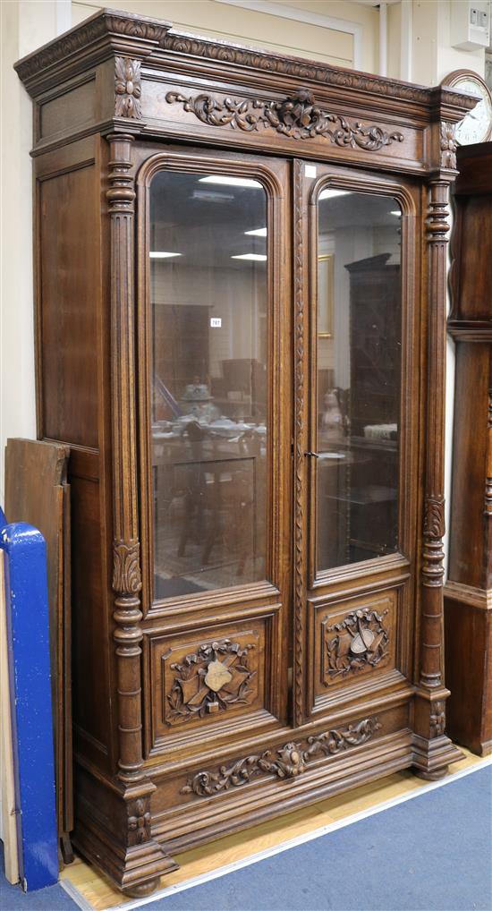 A mid 19th century French carved oak Renaissance style two door glazed bookcase W.130cm, H.220cm